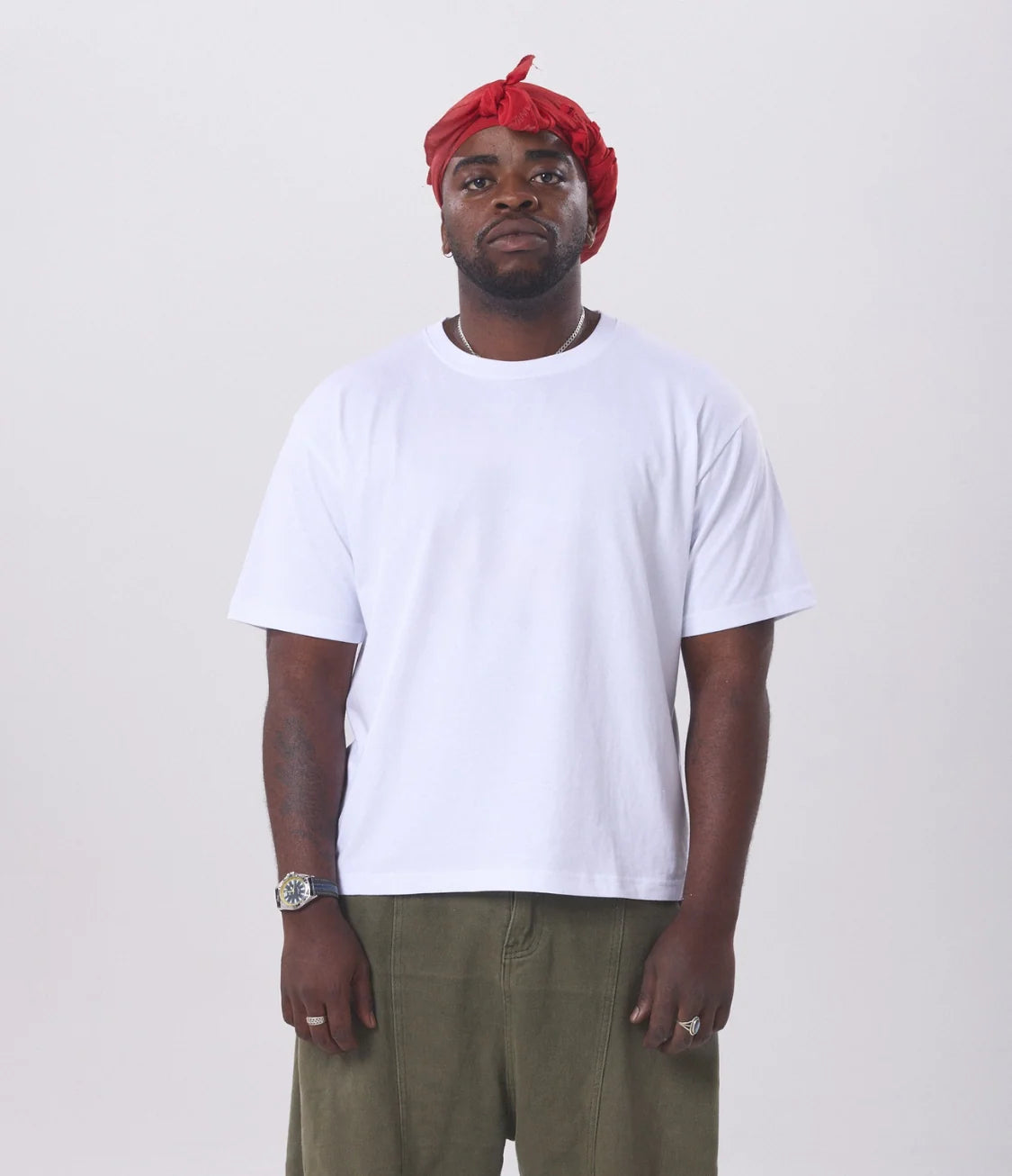 A man wearing a white hemp tee on a white background