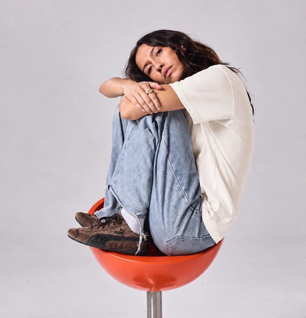 Off White Hemp Tee with girl on orange chair 