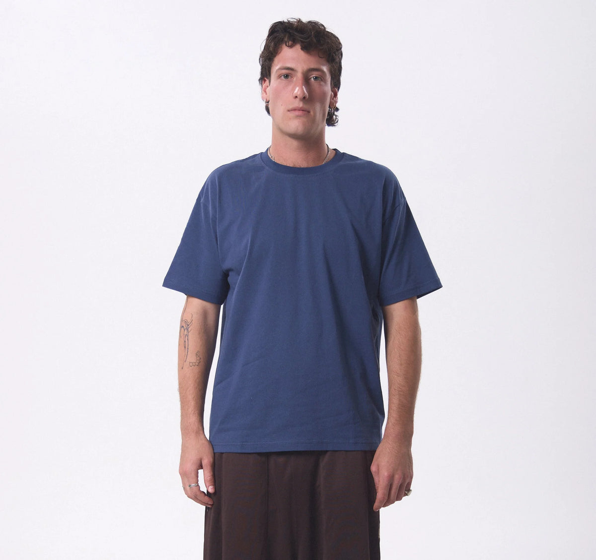 A man wearing our KOA GOODS Petrol Blue Hemp Tee